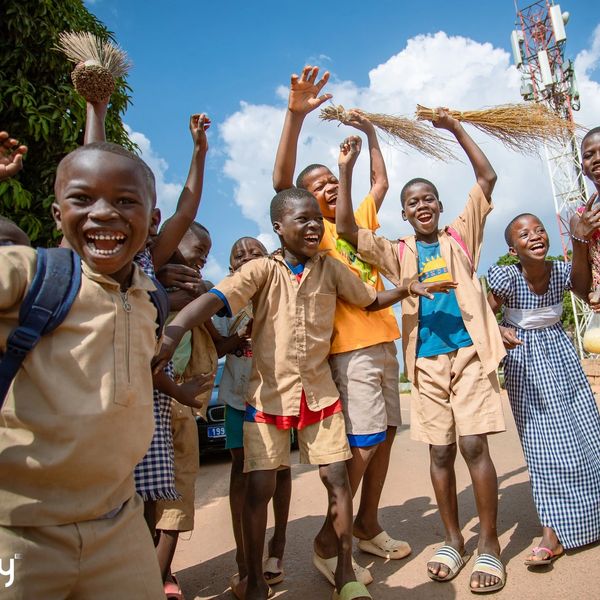 Group of joyful children playing and celebrating outdoors.